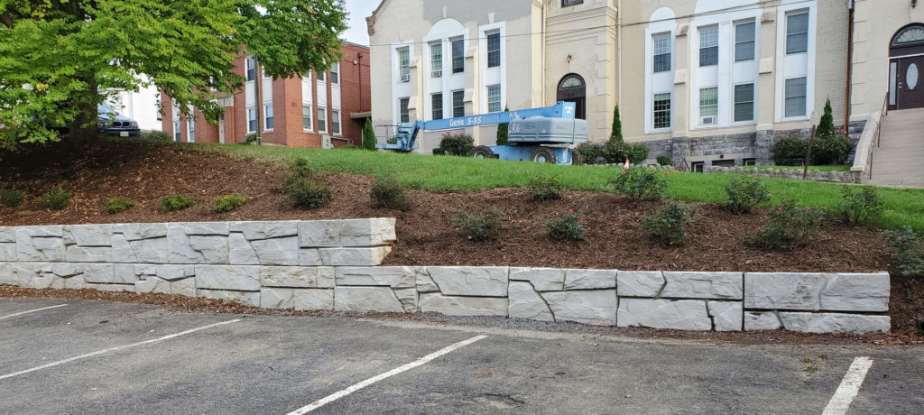 Verti-Block wall showing corner blocks and landscaping covering the blocks.